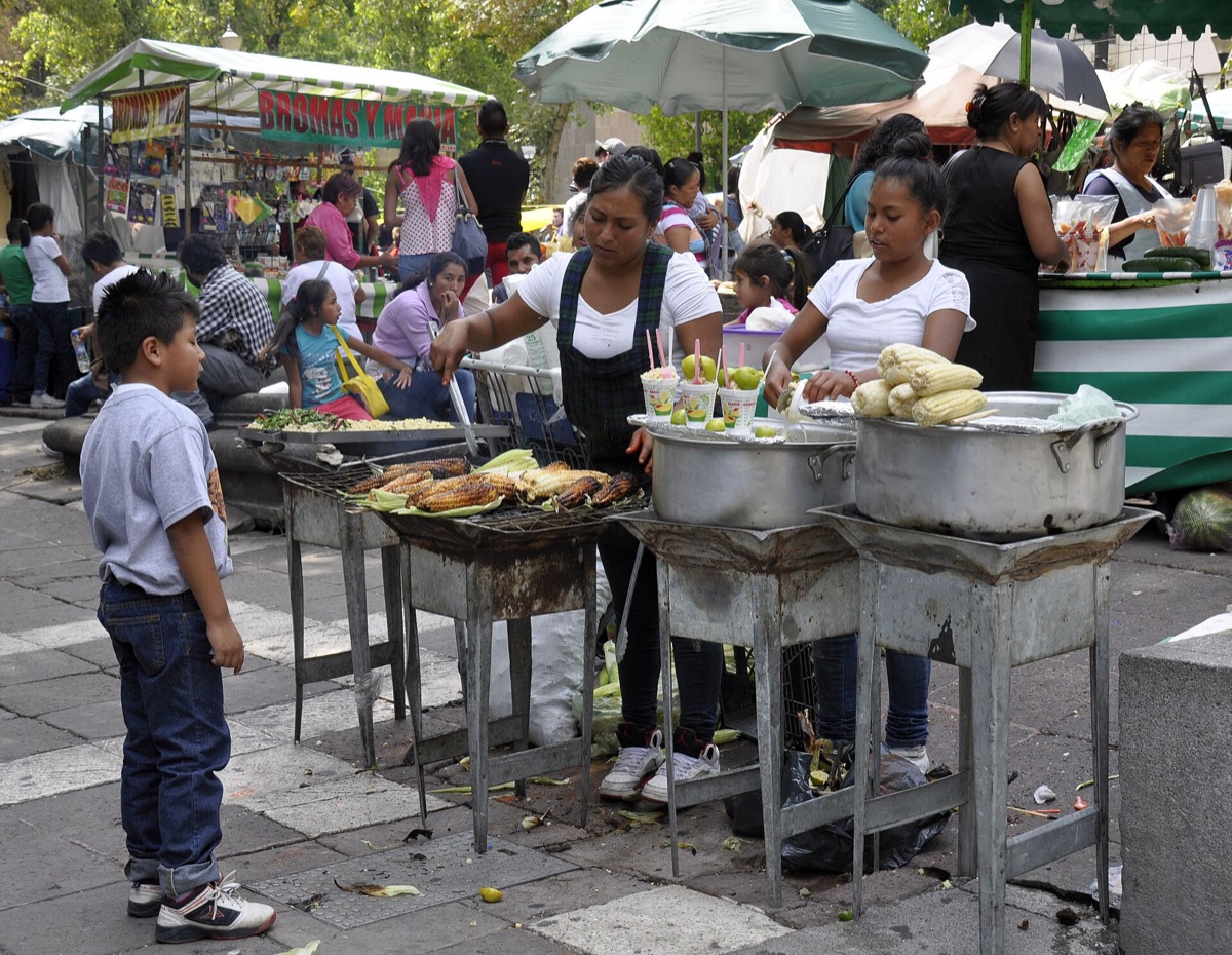 mexico youTube influencer filming a mexican street food vendor